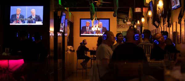 U.S. President Donald Trump and Democratic presidential candidate Joe Biden's presidential debate is broadcast on television and watched at a tavern in San Diego, California, U.S., October 22, 2020 - Sputnik International