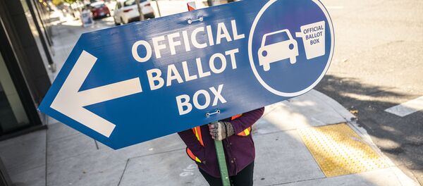 An election worker directs voters to a ballot drop off location on November 2, 2020 in Portland, Oregon. Oregons voting system allows for ballot processing before the start of Election Day. An election worker directs voters to a ballot drop off location on November 2, 2020 in Portland, Oregon. Oregons voting system allows for ballot processing before the start of Election Day. - Sputnik International
