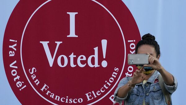 A woman takes a photo in front of an I Voted sign at a San Francisco Department of Elections voting center in San Francisco, Monday, Nov. 2, 2020, ahead of Election Day.  - Sputnik International