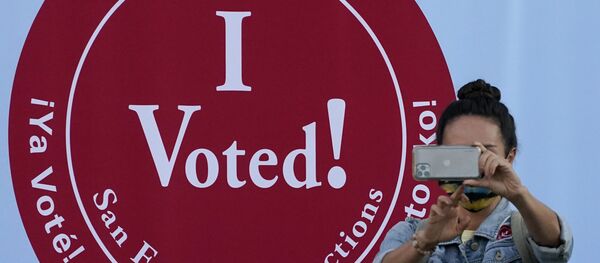A woman takes a photo in front of an I Voted sign at a San Francisco Department of Elections voting center in San Francisco, Monday, Nov. 2, 2020, ahead of Election Day. A woman takes a photo in front of an I Voted sign at a San Francisco Department of Elections voting center in San Francisco, Monday, Nov. 2, 2020, ahead of Election Day. - Sputnik International