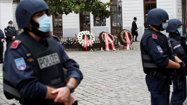 Police officers stand guard at the site of a wreath laying ceremony after a gun attack in Vienna, Austria November 3, 2020. - Sputnik International