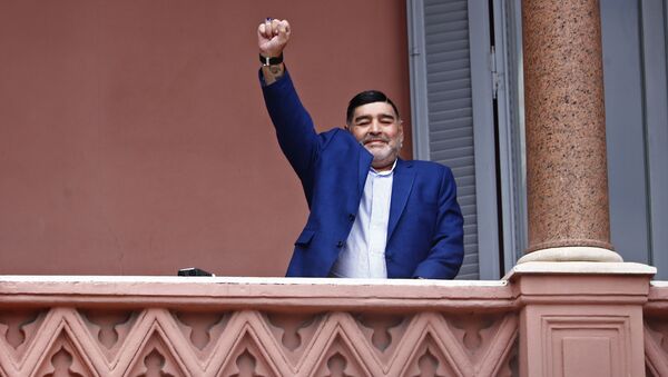 Former soccer great Diego Maradona acknowledges fans below at the Casa Rosada government house after his meeting with Argentine President Alberto Fernandez in Buenos Aires, Argentina, Thursday, Dec. 26, 2019. - Sputnik International