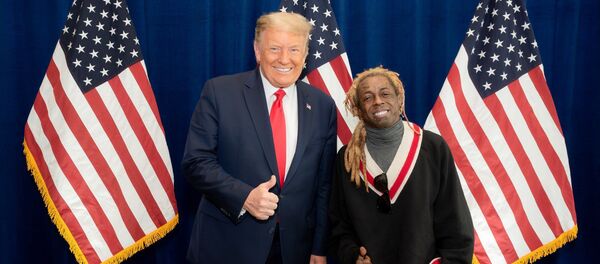 American rapper Lil Wayne poses for a photo with US President Donald Trump at the president's resort in Doral, Florida, on 29 October. - Sputnik International
