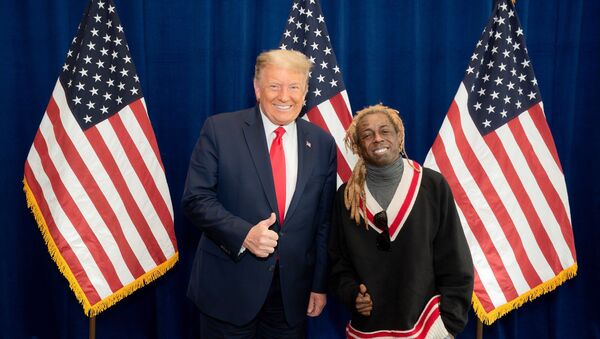 American rapper Lil Wayne poses for a photo with US President Donald Trump at the president's resort in Doral, Florida, on 29 October. - Sputnik International
