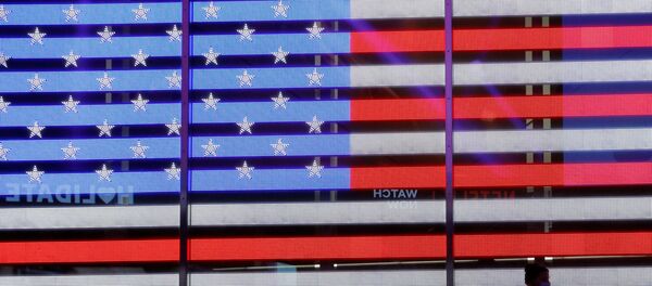 People stand next to a screen displaying a U.S. flag in Times Square during the 2020 U.S. presidential election in New York City, New York, U.S. November 4, 2020. - Sputnik International