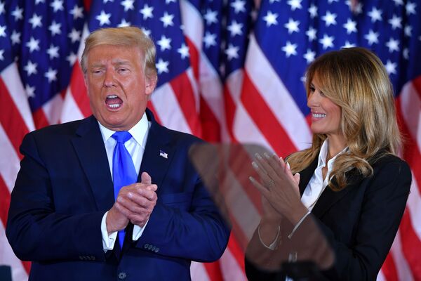 US President Donald Trump claps alongside First Lady Melania Trump after speaking during election night in the East Room of the White House in Washington, DC, early on 4 November 2020.  - Sputnik International