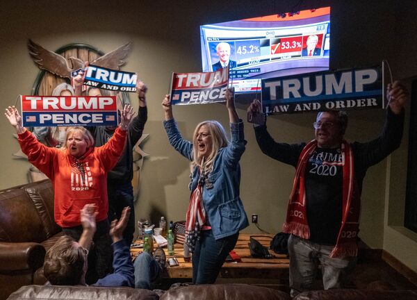 Supporters of the US President celebrate as they watch Ohio being called for Donald Trump at a Republican watch party at Huron Valley Guns in New Hudson, Michigan, 3 November 2020. - Sputnik International