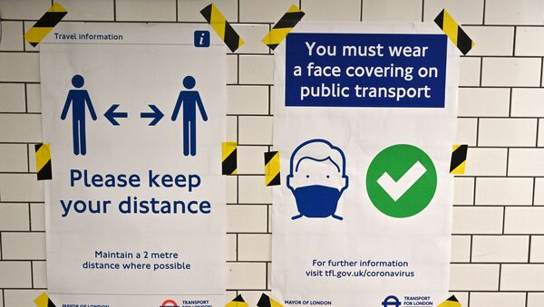Posters advise people on social distancing and the wearing of face coverings on the underground network, at Notting Hill tube station in London, on June 15, 2020 after new rules make wearing face coverings on public transport compulsory while the UK further eases its coronavirus lockdown. - Sputnik International