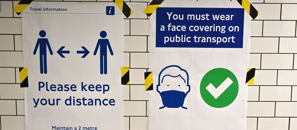 Posters advise people on social distancing and the wearing of face coverings on the underground network, at Notting Hill tube station in London, on June 15, 2020 after new rules make wearing face coverings on public transport compulsory while the UK further eases its coronavirus lockdown. Posters advise people on social distancing and the wearing of face coverings on the underground network, at Notting Hill tube station in London, on June 15, 2020 after new rules make wearing face coverings on public transport compulsory while the UK further eases its coronavirus lockdown. - Sputnik International
