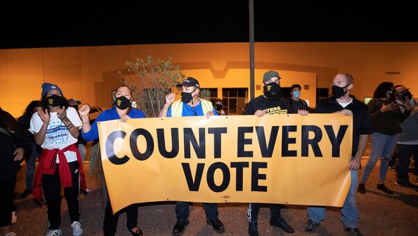 Counter-protesters, organized by Make the Road Action Nevada and PLAN Action, hold a banner during a Stop the Steal protest by supporters of U.S. President Donald Trump at the Clark County Election Center in North Las Vegas, Nevada, U.S. November 4, 2020.  - Sputnik International
