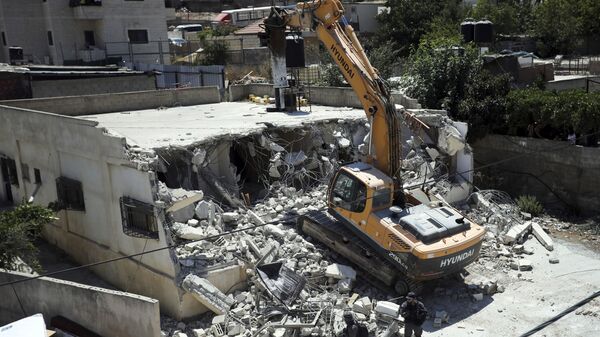 FILE - In this Aug. 21, 2019 file photo, Israeli authorities demolish a Palestinian owned house in east Jerusalem - Sputnik International
