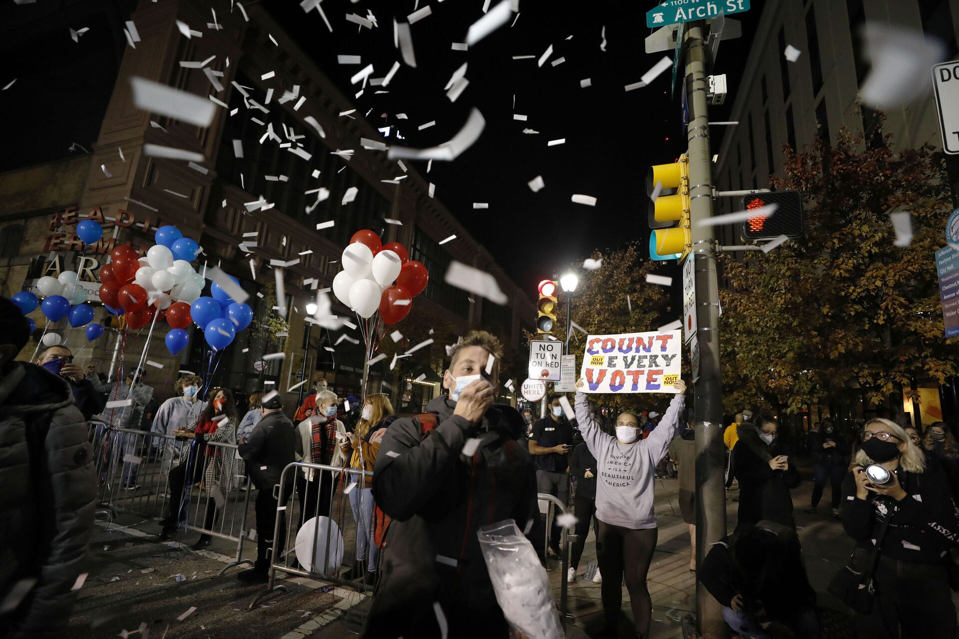 A demonstrator tosses confetti outside the Pennsylvania Convention Center where votes are being counted, Thursday, Nov. 5, 2020, in Philadelphia, following Tuesday's election. - Sputnik International, 1920, 07.09.2021