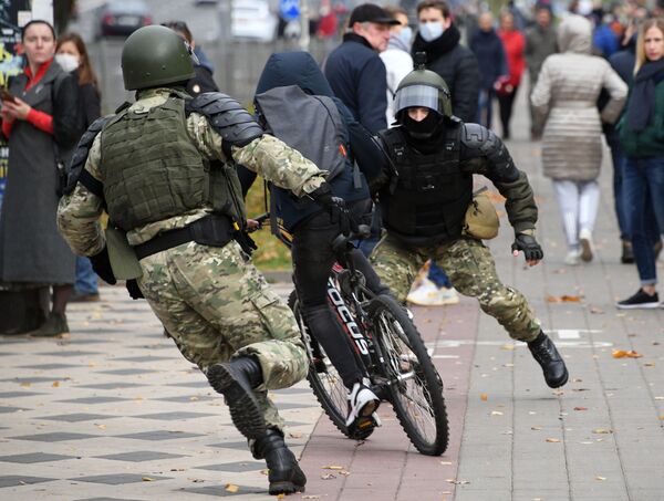 Law enforcement forces trying to stop a bicyclist during an unauthorised rally in Minsk, Belarus. - Sputnik International