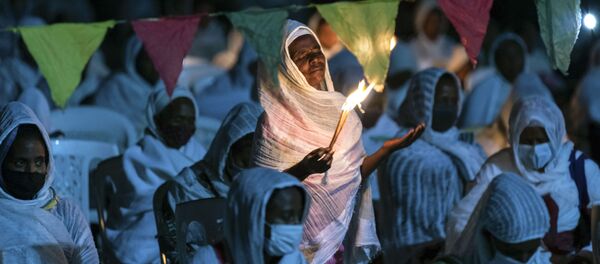 Ethiopian Orthodox Christians light candles and pray for peace during a church service at the Medhane Alem Cathedral in the Bole Medhanealem area of the capital Addis Ababa, Ethiopia Thursday, 5  November 2020.  - Sputnik International