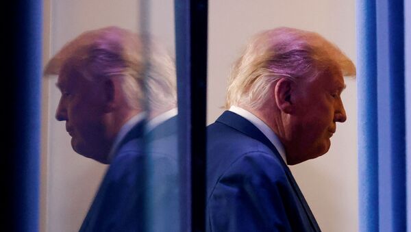 U.S. President Donald Trump is reflected as he departs after speaking about the 2020 U.S. presidential election results in the Brady Press Briefing Room at the White House in Washington, U.S., November 5, 2020. - Sputnik International