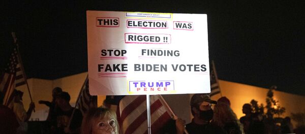 Judy Goff, a supporter of President Donald Trump, holds a sign during a Stop the Steal protest at the Clark County Election Center in North Las Vegas, Nevada, U.S. November 5, 2020. REUTERS/Steve Marcus Judy Goff, a supporter of President Donald Trump, holds a sign during a Stop the Steal protest at the Clark County Election Center in North Las Vegas, Nevada, U.S. November 5, 2020. REUTERS/Steve Marcus - Sputnik International