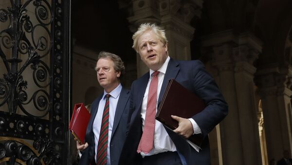 British Prime Minister Boris Johnson walks with Britain's Secretary of State for Scotland Alister Jack, left, into Downing Street, after attending a cabinet meeting at the Foreign Office in London on July 21, 2020. The countries which top the rankings of COVID-19 deaths globally are led by populist, mold-breaking leaders like Johnson. The U.S., Brazil, the United Kingdom and Mexico all are led by leaders who have been skeptical of the scientists and who initially minimized the disease. And their four countries alone account for half of the total 585,000 COVID-19 deaths worldwide so far, according to statistics tracked by Johns Hopkins University. - Sputnik International
