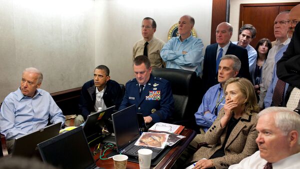  U.S. President Barack Obama (2nd L) and Vice President Joe Biden (L), along with members of the national security team, receive an update on the mission against Osama bin Laden in the Situation Room of the White House, May 1, 2011 - Sputnik International
