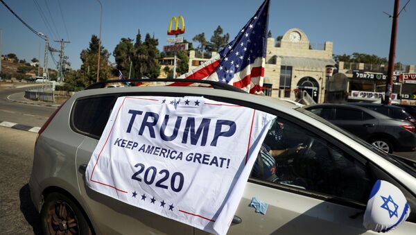 An American flag and banner cover a car, part of a convoy to the U.S. Embassy in Jerusalem to show support for U.S. President Donald Trump, ahead of the upcoming U.S. election, near Sho'eva, Israel October 27, 2020. REUTERS/Ammar Awad/File Photo - Sputnik International