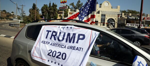 An American flag and banner cover a car, part of a convoy to the U.S. Embassy in Jerusalem to show support for U.S. President Donald Trump, ahead of the upcoming U.S. election, near Sho'eva, Israel October 27, 2020. REUTERS/Ammar Awad/File Photo - Sputnik International