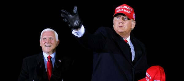U.S. President Donald Trump hands out caps to supporters next to Vice President Mike Pence, as he holds a campaign rally at Gerald R. Ford International Airport in Grand Rapids, Michigan, U.S., November 2, 2020. REUTERS/Carlos Barria U.S. President Donald Trump hands out caps to supporters next to Vice President Mike Pence, as he holds a campaign rally at Gerald R. Ford International Airport in Grand Rapids, Michigan, U.S., November 2, 2020. REUTERS/Carlos Barria - Sputnik International