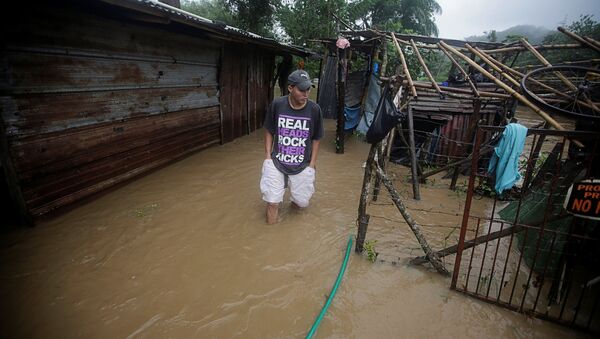 A man walks outside his house affected by a flooding caused by rains from Storm Eta, in Tela, Honduras November 4, 2020. - Sputnik International
