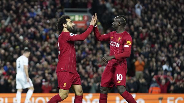 Liverpool's Mohamed Salah, front left, celebrates with Liverpool's Sadio Mane after scoring his side's opening goal during the English Premier League soccer match between Liverpool and Sheffield United at Anfield Stadium, Liverpool, England, Thursday, Jan. 2, 2020 - Sputnik International