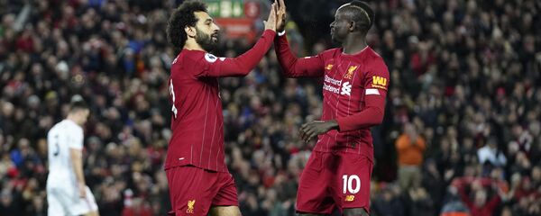 Liverpool's Mohamed Salah, front left, celebrates with Liverpool's Sadio Mane after scoring his side's opening goal during the English Premier League soccer match between Liverpool and Sheffield United at Anfield Stadium, Liverpool, England, Thursday, Jan. 2, 2020 - Sputnik International