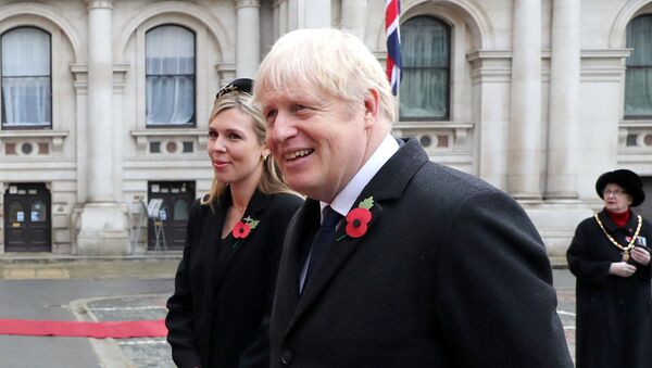Britain's Prime Minister Boris Johnson with partner Carrie Symonds attend the National Service of Remembrance at The Cenotaph on Whitehall amid the coronavirus pandemic in London, Britain November 8, 2020 - Sputnik International