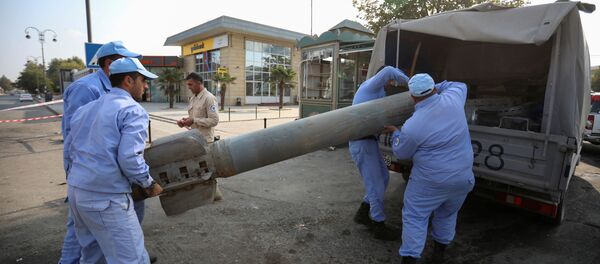 Azeri investigators load a fragment of an artillery shell in a street recently hit by shelling during a military conflict over the breakaway region of Nagorno-Karabakh, in the town of Barda, Azerbaijan October 29, 2020 Azeri investigators load a fragment of an artillery shell in a street recently hit by shelling during a military conflict over the breakaway region of Nagorno-Karabakh, in the town of Barda, Azerbaijan October 29, 2020 - Sputnik International