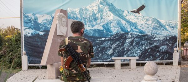 An Armenian soldier looks at the picture sitting on a stone bench in Martakert, the self-proclaimed Nagorno-Karabakh Republic An Armenian soldier looks at the picture sitting on a stone bench in Martakert, the self-proclaimed Nagorno-Karabakh Republic - Sputnik International