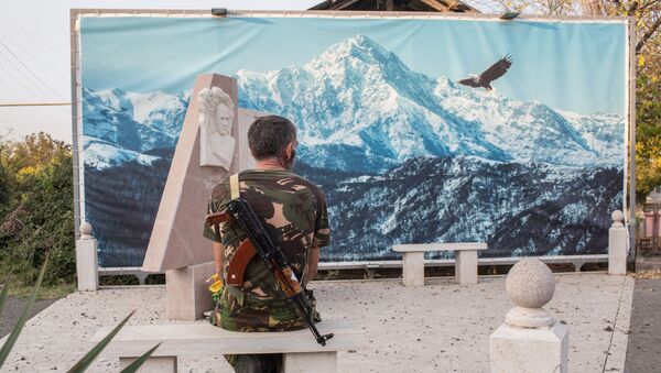 An Armenian soldier looks at the picture sitting on a stone bench in Martakert, the self-proclaimed Nagorno-Karabakh Republic - Sputnik International