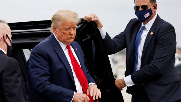 U.S. President Donald Trump holds a 'Make America Great Again' cap while arriving to board Air Force One as he departs Florida for campaign travel to North Carolina, Pennsylvania, Michigan and Wisconsin at Miami International Airport in Miami, Florida, U.S., November 2, 2020 - Sputnik International
