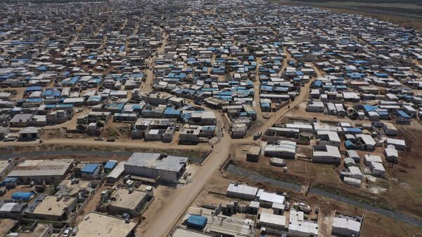 This April 19, 2020 file photo shows a large refugee camp on the Syrian side of the border with Turkey, near the town of Atma, in Idlib province, Syria - Sputnik International