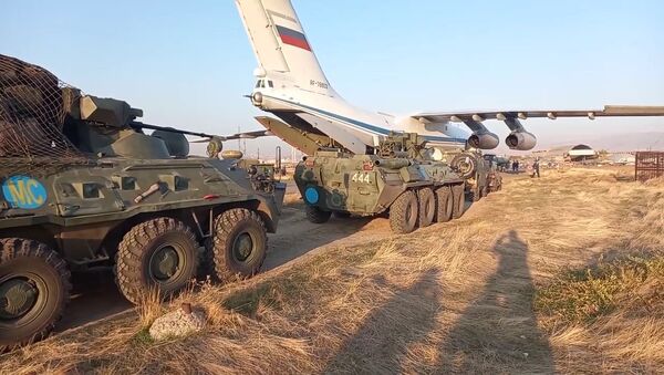 In this handout video grab released by the Russian Defence Ministry, Russian peacekeepers' military equipment that is being redeployed to the Nagorno-Karabakh conflict zone, is unloaded from transport aircraft at Erebuni Airport, outside Yerevan, Armenia - Sputnik International