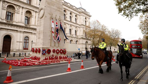 Mounted police officers pass the Cenotaph with wreaths on it in Whitehall, London, England, 11 November 2020. - Sputnik International