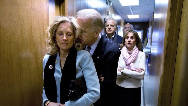 Delaware Senator and presidential candidate for the Democrats, Joe Biden, rests his head on the shoulder of his wife, Jill, as they stand in a hallway waiting for him to be introduced into a a rally at the UAW Hall in Dubuque, Iowa, on the day of the Iowa caucus Thursday, 3 January 2008. - Sputnik International