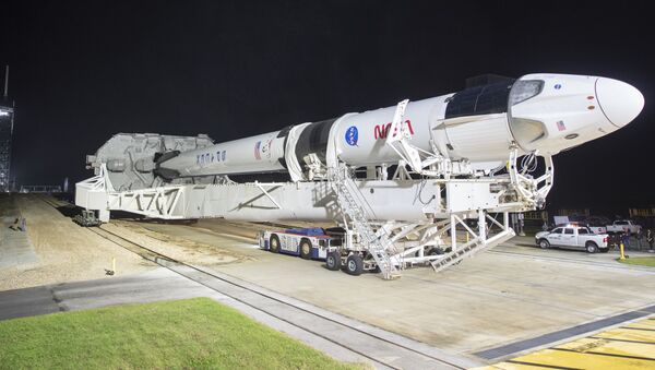 In this Monday, Nov. 9, 2020 photo provided by NASA, a SpaceX Falcon 9 rocket and Crew Dragon capsule is rolled out of the horizontal integration facility at Launch Complex 39A, as preparations continue for a crewed mission at NASA's Kennedy Space Center in Florida - Sputnik International