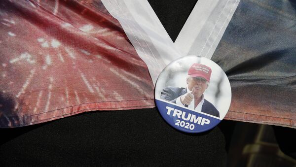 A woman wears a Trump button as supporters of President Donald Trump protest outside the Pennsylvania Convention Center, where vote counting continues, in Philadelphia, Monday, Nov. 9, 2020 - Sputnik International