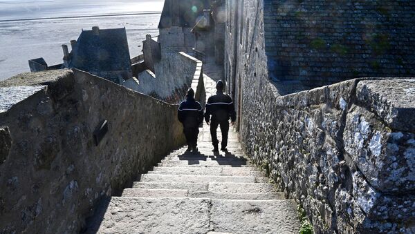 French gendarmes patrol on the defensive wall walk in Le Mont-Saint-Michel, Normandy, northwestern France, on November 12, 2020, as France is on a second lockdown aimed at containing the spread of Covid-19 pandemic caused by the novel coronavirus. - Sputnik International