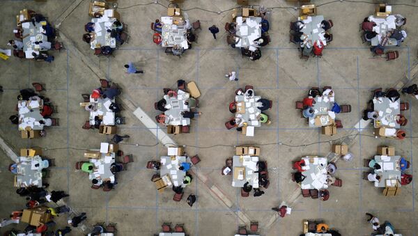 Electoral workers count ballots from briefcases with uncounted ballots for the election of local leaders in a tabulation centre at the Roberto Clemente Coliseum in Puerto Rico - Sputnik International