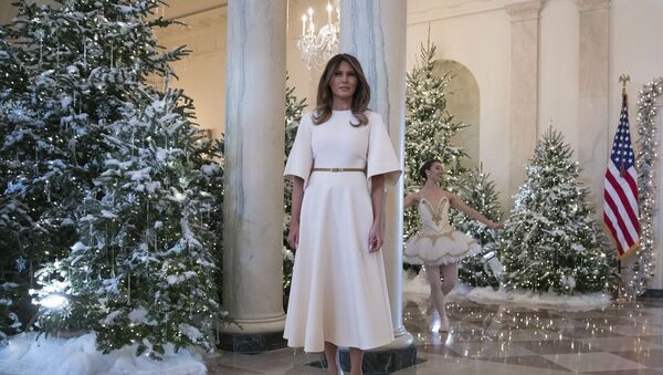 First lady Melania Trump pauses as a ballerina performs a piece from The Nutcracker behind her among the 2017 holiday decorations in the Grand Foyer of the White House in Washington, 27 November 2017 - Sputnik International