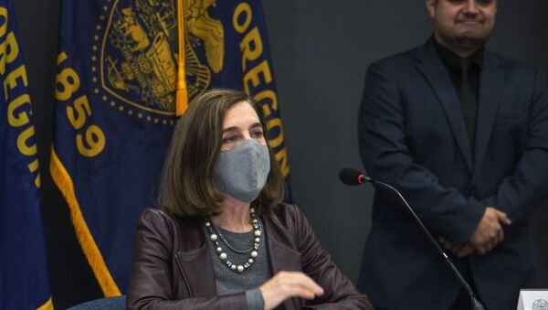 Oregon Gov. Kate Brown attends a news conference Tuesday, Nov. 10, 2020, in Portland, Ore. Brown and Oregon health officials warned Tuesday of the capacity challenges facing hospitals as COVID-19 case counts continue to spike in the state. - Sputnik International