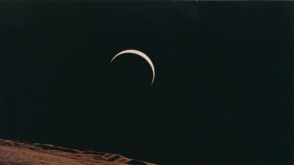 Crescent Earth rising beyond the Moon's barren horizon, 1971.  - Sputnik International