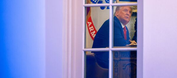 U.S. President Donald Trump sits at his desk in the Oval Office after returning at the conclusion of an event about the Operation Warp Speed program, the joint Defense Department and HHS initiative that has struck deals with several drugmakers in an effort to help speed up the search for effective treatments for the ongoing coronavirus disease (COVID-19) pandemic, held in the Rose Garden of the White House in Washington, U.S., November 13, 2020. - Sputnik International