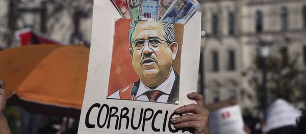 A protester holds up a poster adorned with play money with the Spanish word for corruption and an image depicting Peru's newly sworn-in president Manuel Merino - Sputnik International