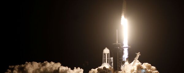 A SpaceX Falcon 9 rocket, with the Crew Dragon capsule, is launched carrying four astronauts on the first operational NASA commercial crew mission at  Kennedy Space Center in Cape Canaveral, Florida, U.S. November 15, 2020. - Sputnik International