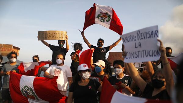People hold signs and Peruvian flags during a rally after Peru's interim President Manuel Merino resigned, in Rio de Janeiro, Brazil, November 15, 2020.  - Sputnik International
