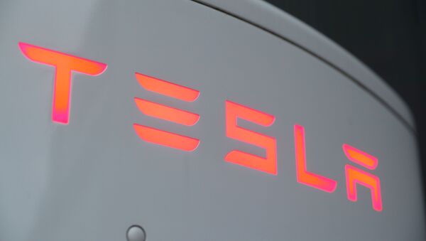 The logo of Tesla is seen at a Tesla Supercharger station in Dietikon, Switzerland October 21, 2020. - Sputnik International