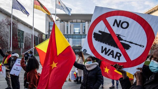 Pro-Tigrayan demonstrators display placards during a protest in front of the Chancellery in Berlin on November 12, 2020, over a week-old conflict in northern Ethiopia between the regional ruling party, the Tigray People's Liberation Front (TPLF), and the government of Prime Minister Abiy Ahmed. - Sputnik International